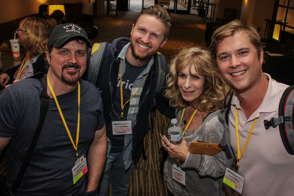 (left to right) TAXI members James Thacker, Brandon Mathias, Beth Wernick (CEO, Imaginary Friends), and Austin Fillingo look to be having a warm reunion at this year’s convention.