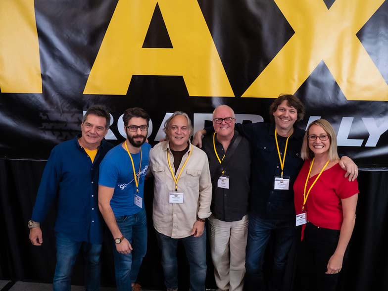 Jonathan Cain of Journey, triumphantly holding up his Lifetime Achievement award prior to doing his Keynote Interview with TAXI’s Michael Laskow.