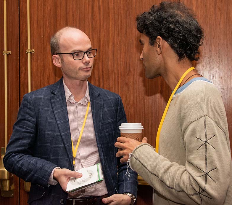 Music Library owner Pedro Costa (left) takes a few minutes to chat with a TAXI member outside the ballroom.