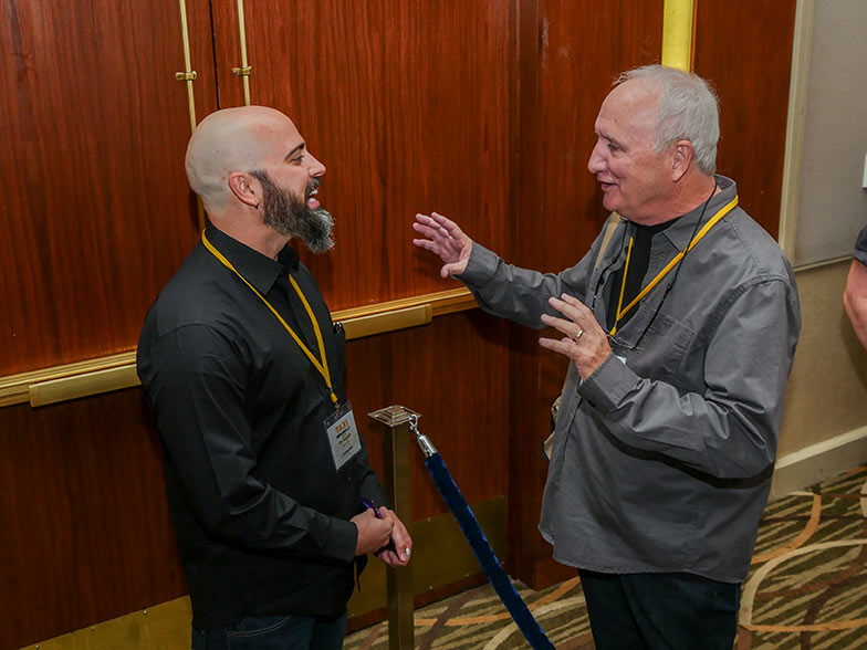 TAXI member Brian Curtin (right) enjoys a little one-on-one chat with reality TV video editor Timothy Hogarth. 