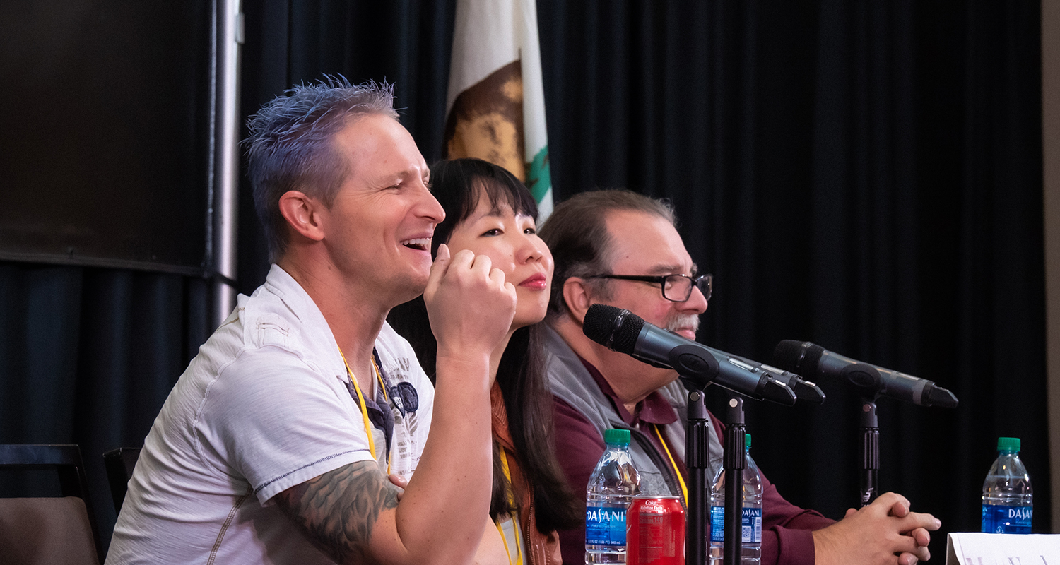 Panelist (l to r) Erin Jacobson, Bob Mair, Pedro Costa, and Michael Eames (on Michael Laskow's laptop) enjoy a light moment during their panel at the TAXI Road Rally.