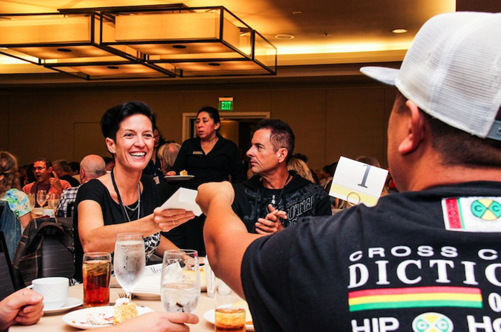 TAXI A&R person and Film/TV music expert Brooke Ferri takes some music from a member during the Mentor Lunch at our 20th Road Rally.