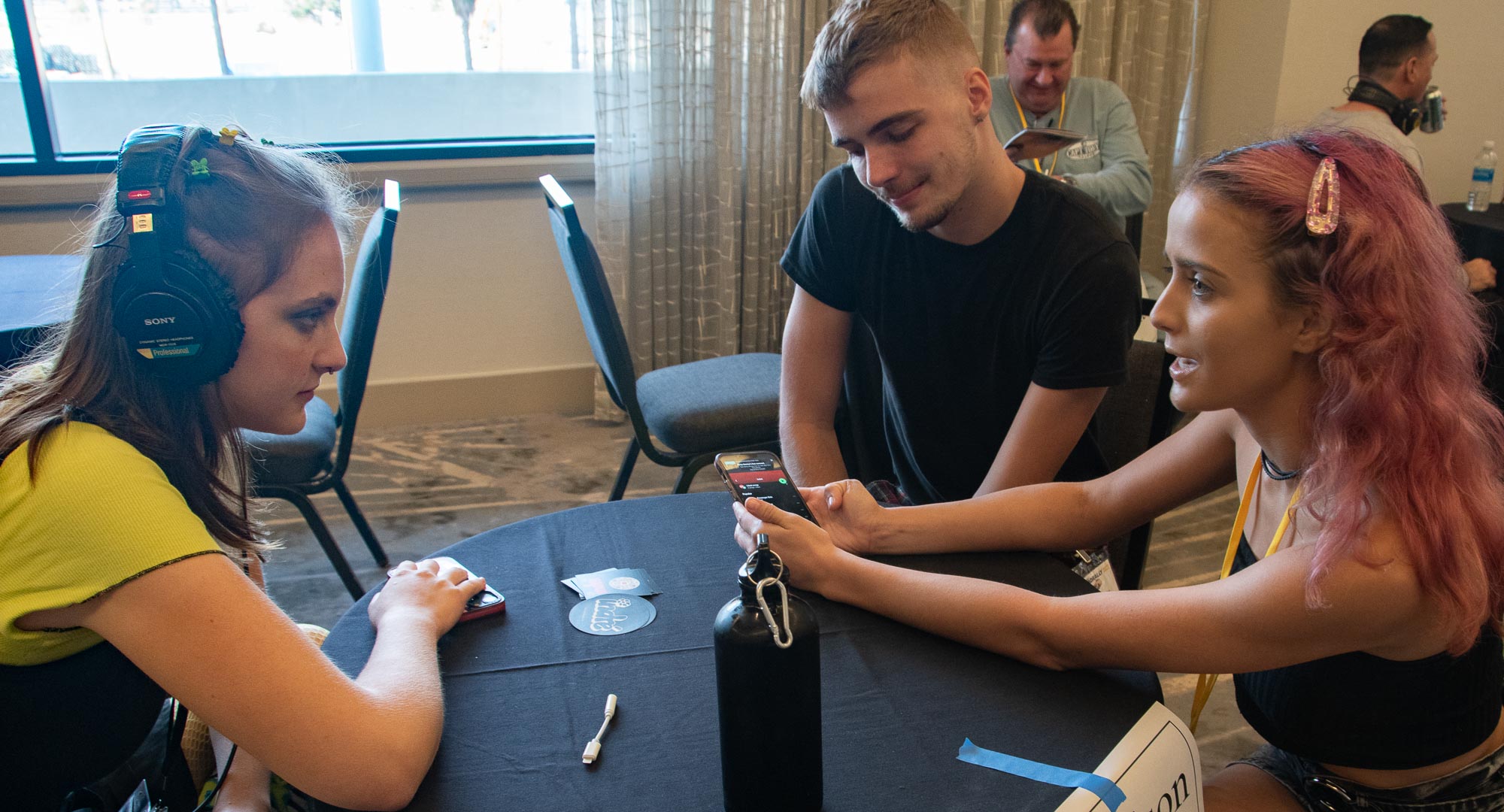 Music Licensing Executive, Madison Tasker gives feedback on a song from the band, Indré, during the One-to-One Mentor sessions at the Rally. Band members Maddie and Angelo Indré seem to be paying close attention!